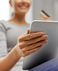 Image showing woman with tablet pc and credit card at home