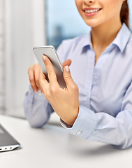 Image showing businesswoman with smartphone at office
