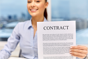 Image showing happy businesswoman holding contract at office