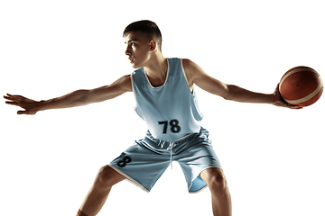 Image showing Full length portrait of a young basketball player with ball