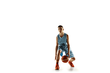 Image showing Full length portrait of a young basketball player with ball