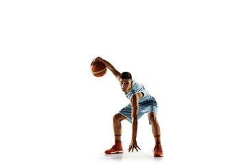 Image showing Full length portrait of a young basketball player with ball