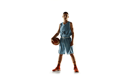 Image showing Full length portrait of a young basketball player with ball