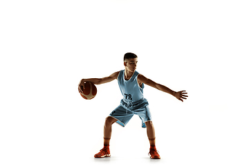 Image showing Full length portrait of a young basketball player with ball