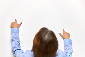 Image showing businesswoman touching white table with fingers