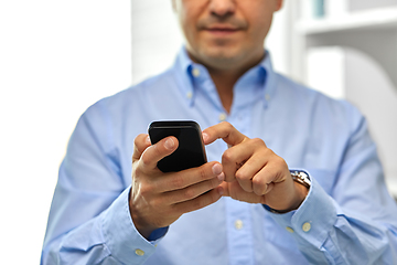 Image showing close up of businessman using smartphone