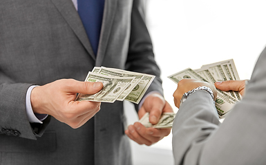 Image showing close up of businessmen's hands holding money