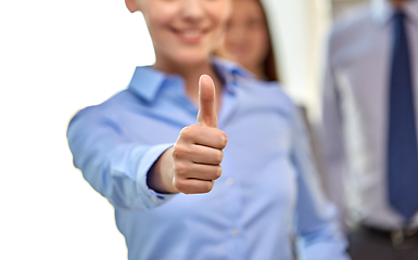 Image showing close up of happy businesswoman showing thumbs up