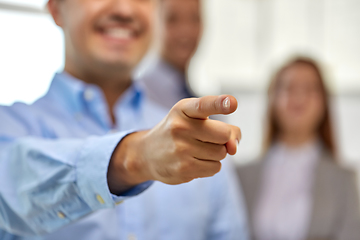 Image showing close up of smiling businessman pointing finger