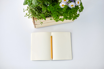 Image showing notebook with herbs and flowers in wooden box