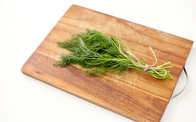 Image showing bunch of dill on wooden cutting board