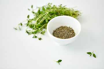 Image showing fresh thyme and dry seasoning on white background