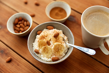 Image showing oatmeal with banana and almond on wooden table