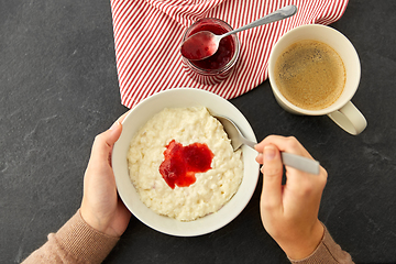 Image showing hands with porridge breakfast and cup of coffee