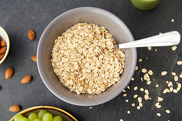 Image showing oatmeal cereals in bowl with spoon