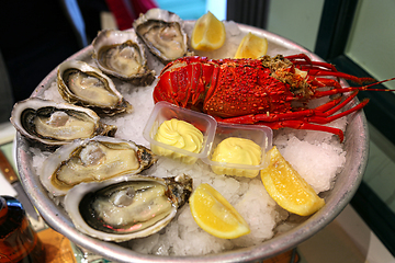 Image showing Large dish with fresh seafood, oysters with lobster with lemon a