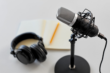 Image showing headphones, microphone and notebook with pencil