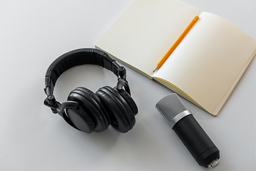 Image showing headphones, microphone and notebook with pencil