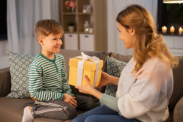 Image showing mother giving present to her little son at home