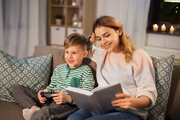 Image showing happy mother with little son spending time at home