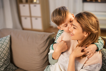 Image showing happy smiling mother and son hugging at home