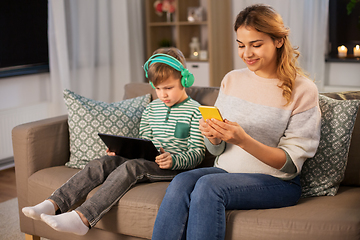 Image showing mother and son using gadgets at home