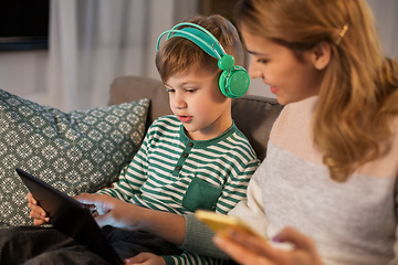 Image showing mother and son using gadgets at home