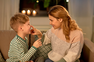 Image showing happy mother touching little son's nose at home