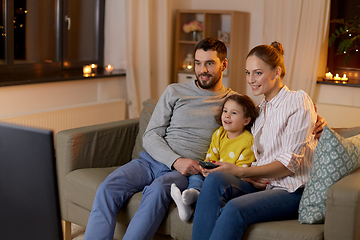 Image showing happy family watching tv at home at night