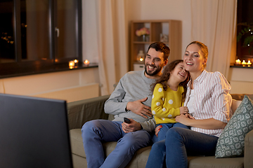 Image showing happy family watching tv at home at night