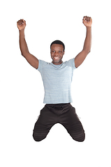 Image showing Happy African man with kneeling looking up