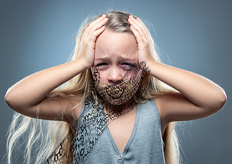 Image showing Sad and frightened little girl with bloodshot and bruised eyes, fiction of happiness