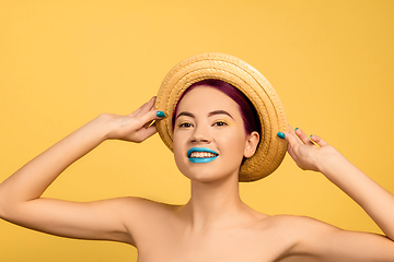 Image showing Portrait of beautiful young woman with bright make-up isolated on yellow studio background