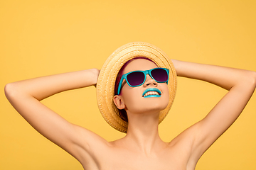 Image showing Portrait of beautiful young woman with bright make-up isolated on yellow studio background