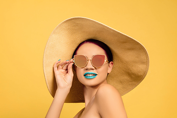 Image showing Portrait of beautiful young woman with bright make-up isolated on yellow studio background