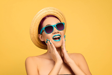 Image showing Portrait of beautiful young woman with bright make-up isolated on yellow studio background