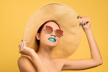 Image showing Portrait of beautiful young woman with bright make-up isolated on yellow studio background