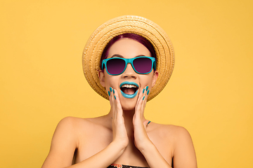 Image showing Portrait of beautiful young woman with bright make-up isolated on yellow studio background