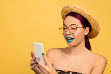 Image showing Portrait of beautiful young woman with bright make-up isolated on yellow studio background