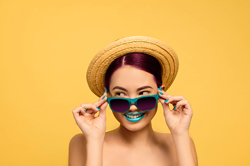 Image showing Portrait of beautiful young woman with bright make-up isolated on yellow studio background