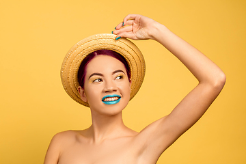 Image showing Portrait of beautiful young woman with bright make-up isolated on yellow studio background