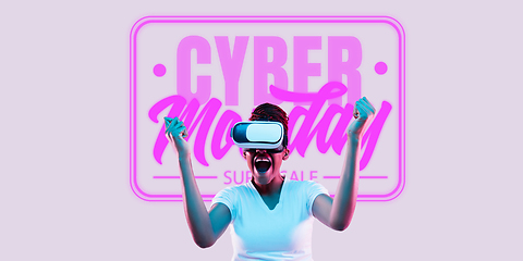 Image showing Half-length close up portrait of young woman in neon light with cyber monday lettering