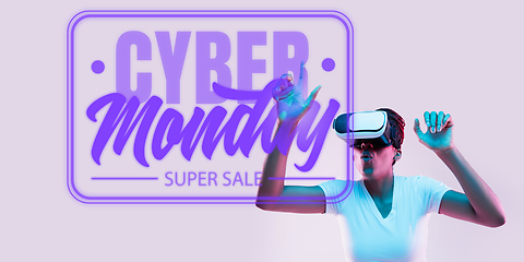 Image showing Half-length close up portrait of young woman in neon light with cyber monday lettering