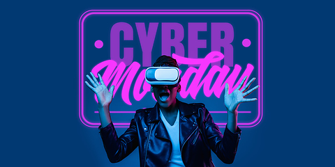 Image showing Half-length close up portrait of young woman in neon light with cyber monday lettering