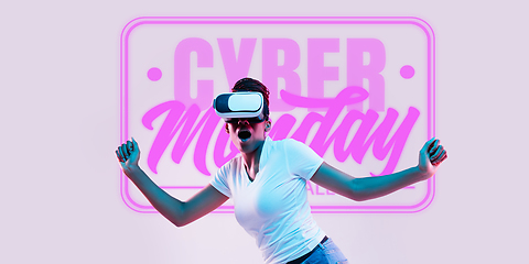 Image showing Half-length close up portrait of young woman in neon light with cyber monday lettering