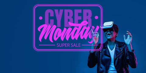 Image showing Half-length close up portrait of young woman in neon light with cyber monday lettering