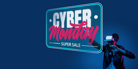 Image showing Half-length close up portrait of young woman in neon light with cyber monday lettering