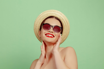 Image showing Portrait of beautiful young woman with bright make-up isolated on green studio background