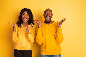 Image showing Young emotional african-american man and woman on yellow background