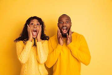 Image showing Young emotional african-american man and woman on yellow background